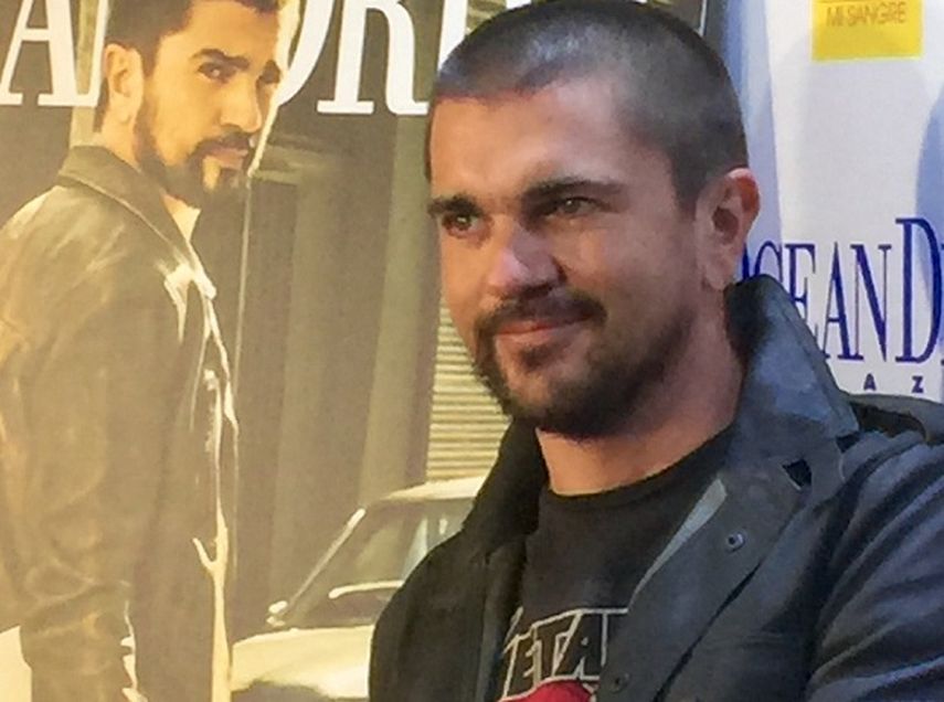 El cantautor colombiano Juanes posa junto al póster que ilustra la portada de abril de la revista Ocean Drive. (WILMA HDEZ). 