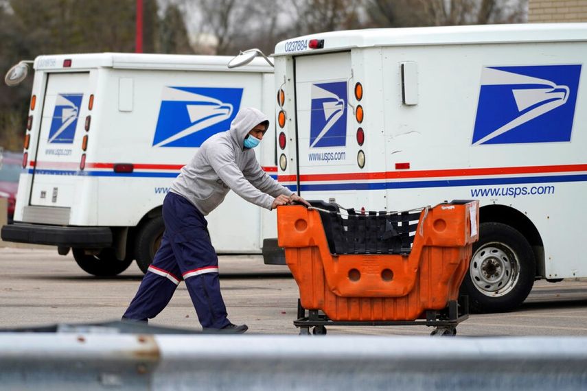 Un empleado del Servicio Postal traslada unos paquetes frente a una oficina en Wheeling, Illinois. &nbsp;