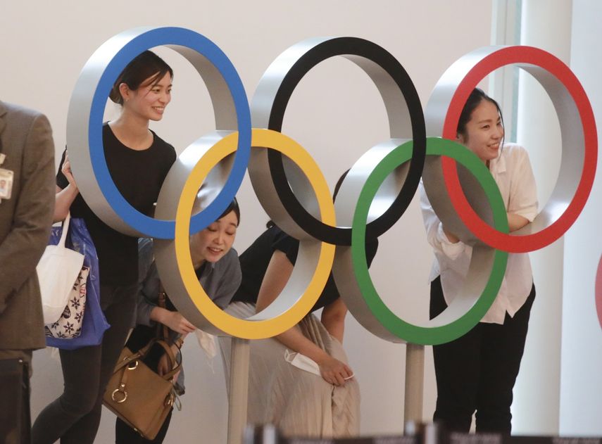 Gente posando para una foto con los anillos olímpicos en el aeropuerto internacional de Haneda, en Tokio, el jueves 8 de julio de 2021.&nbsp;