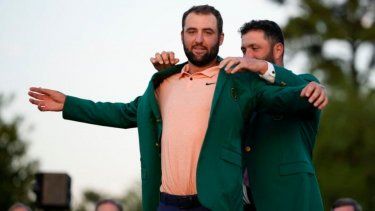 Jon Rahm, de España, pone la chaqueta verde en el ganador Scottie Scheffler después del torneo de golf Masters en el Augusta National Golf Club el domingo 14 de abril de 2024, en Augusta, Georgia.