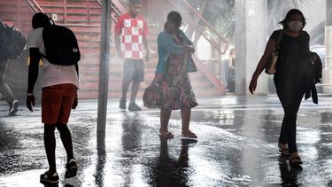 Las personas pasan por un spray de soluci&oacute;n desinfectante en la entrada de una estaci&oacute;n de tren como medida preventiva contra la propagaci&oacute;n del coronavirus COVID-19, estado de Sao Paulo, Brasil, el 14 de abril de 2020. &nbsp;