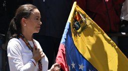 La líder opositora venezolana María Corina Machado sostiene una bandera nacional venezolana mientras hace un gesto desde lo alto de un camión durante una manifestación para protestar por los resultados de las elecciones presidenciales, en Caracas el 3 de agosto de 2024.&nbsp;