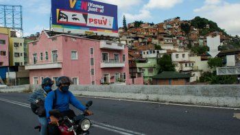 NOTICIA DE VENEZUELA  - Página 4 La-gente-pasa-bicicleta-frente-una-valla-publicitaria-propaganda-politica-que-representa-los-ojos-del-fallecido-presidente-venezolano-hugo-chavez-caracas-el-2-diciembre-2020-antes-las-elecciones-parlamentarias-el-pais-venezolano-celebrara-elecciones-legislativas-el-6-diciembre