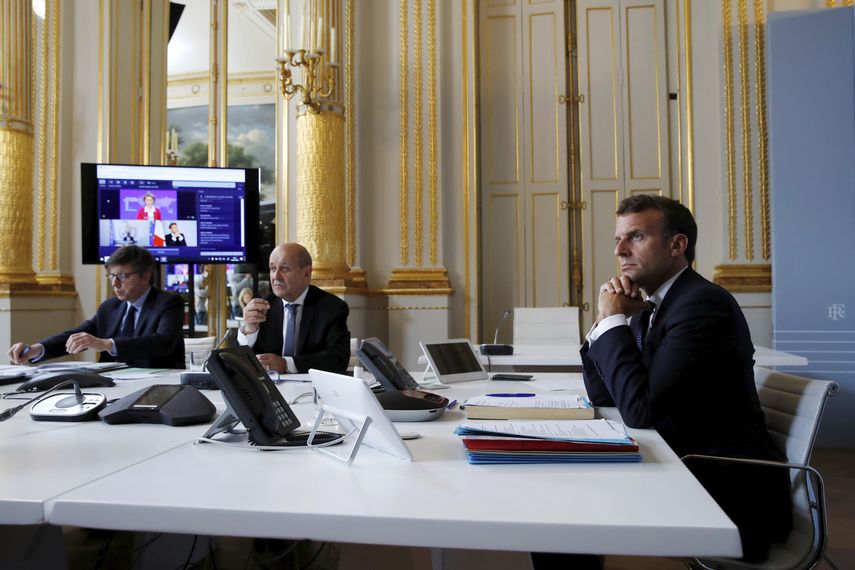 El presidente franc&eacute;s Emmanuel Macron (d) y el ministro de relaciones exteriores franc&eacute;s Jean-Yves le Drian (cent) en una videoconferencia sobre el coronavirus en el Palacio de los El&iacute;seos en Par&iacute;s, el 4 de mayo del 2020.&nbsp;