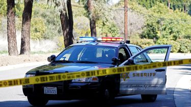 Una patrulla de la policía bloquea una calle durante una investigación de un crimen.