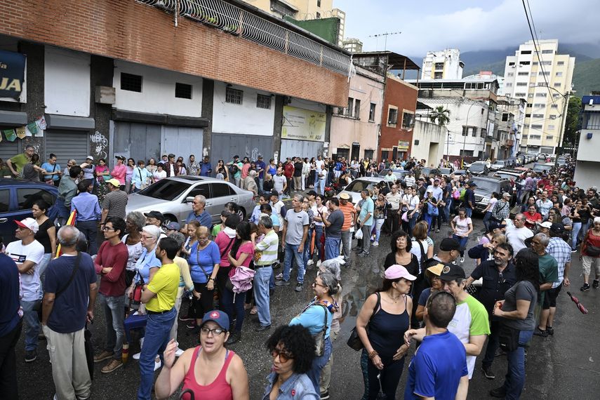 La gente hace cola para votar afuera de un colegio electoral en el barrio La Candelaria de Caracas durante las elecciones primarias de la oposición venezolana el 22 de octubre de 2023.&nbsp; &nbsp;