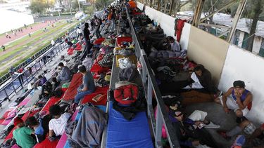 Grupos de migrantes toman un descanso en el complejo deportivo Jesús Martínez Palillo de Ciudad de México.