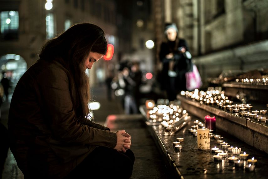 En esta foto de archivo tomada el 14 de noviembre de 2015, una mujer reza frente a un monumento en homenaje a las víctimas de los ataques de París