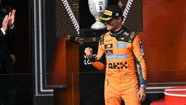 El piloto británico de McLaren, Lando Norris, ganador del Gran Premio de Hungría de Fórmula 1, celebra su victoria mientras pasa junto al trofeo durante la ceremonia de entrega de premios, celebrada el 26 de julio de 2026 en el circuito de Hungaroring, en Mogyorod, cerca de Budapest, Hungría.&nbsp;