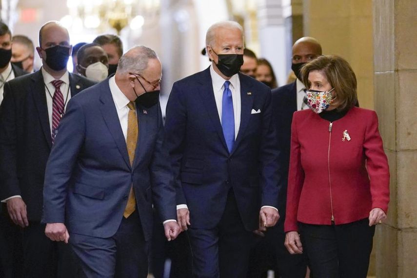 El presidente Joe Biden flanqueado por la presidenta de la Cámara de Representantes, Nancy Pelosi, y el líder de la mayoría demócrata en el Senado, Chuck Schumer.