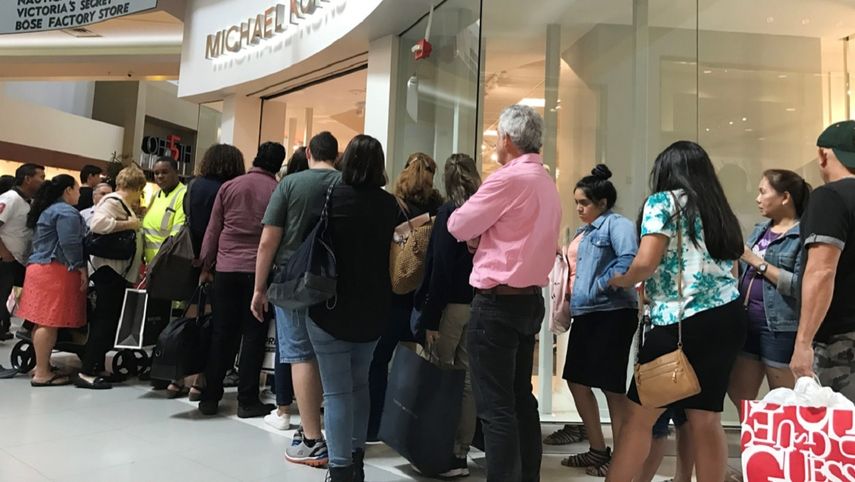 Miamenses hacen fila para entrar a una tienda durante el Black Friday.