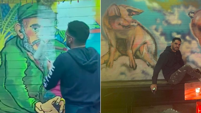 El Sexto tapa el graffiti de Fidel Castro con unos cerdos, en las afueras de un negocio en New Orleans.&nbsp;