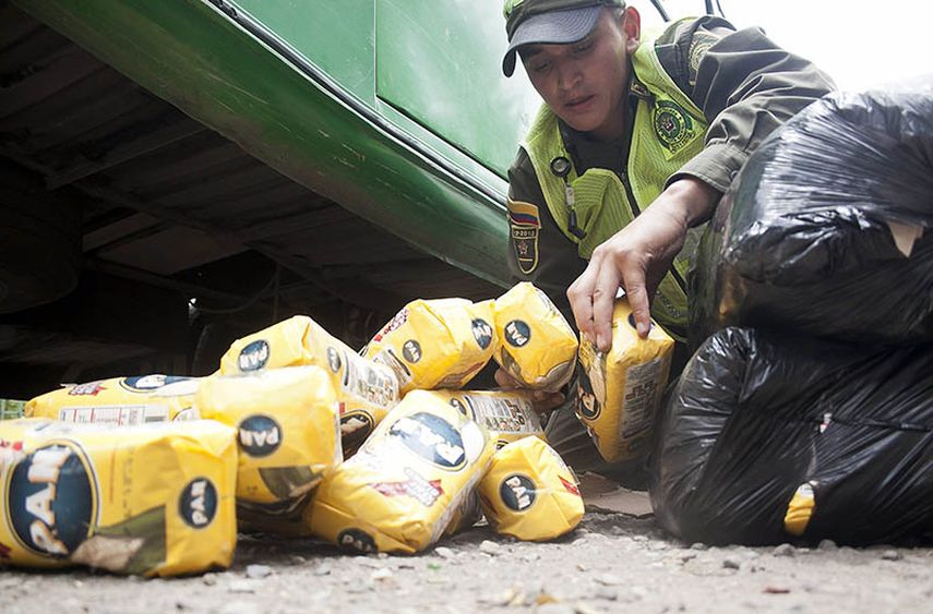 Un guardia confisca paquetes de harina PAN. (EFE)