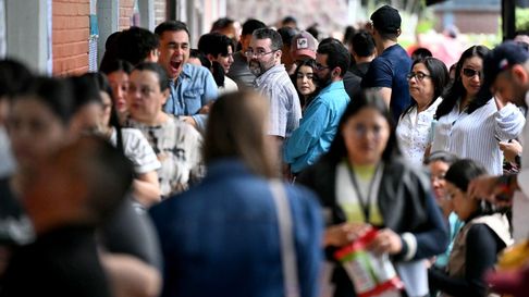 Personas hacen fila para votar en un centro de votación durante las elecciones generales en Tegucigalpa, el 30 de noviembre de 2025. Los hondureños comenzaron a votar para elegir presidente el domingo en medio de amenazas del presidente estadounidense Donald Trump de recortar la ayuda al país si su candidato preferido pierde.