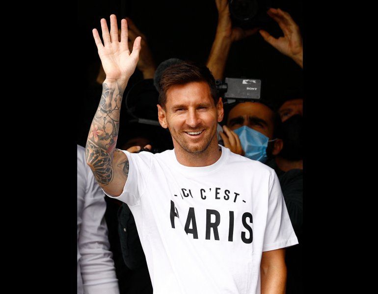 El futbolista argentino Lionel Messi saluda a los aficionados desde una ventana después de aterrizar el 10 de agosto de 2021 en el aeropuerto de Le Bourget, al norte de París, mientras el Paris Saint-Germain busca completar el fichaje de 34 años tras su salida de Barcelona.      