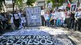 Manifestantes llevan pancartas en contra del régimen de Nicolás Maduro y exijen la libertad para los presos políticos en una protesta ante la Embajada de Brasil en Caracas.