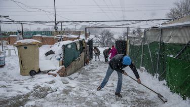 Unas personas palean la nieve en La Cañada Real Galiana, un enorme barrio pobre a las afueras de Madrid, España, considerado uno de los más grandes de Europa, el 8 de enero de 2021.&nbsp;