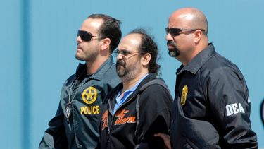 En esta imagen del 13 de mayo de 2008, el paramilitar colombiano Rodrigo Tovar, es escoltado por agentes de la DEA en el aeropuerto de Opa-Locka, Florida.