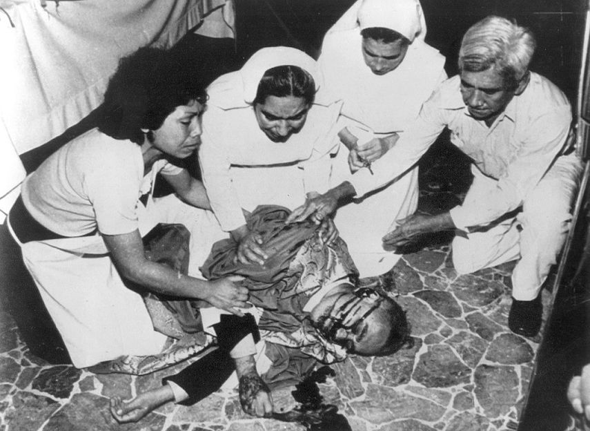 El arzobispo Oscar Arnulfo Romero es atendido después de recibir de mano de cuatro desconocidos, un disparo en el pecho en la iglesia donde celebraba una misa, 1980. (EFE). 