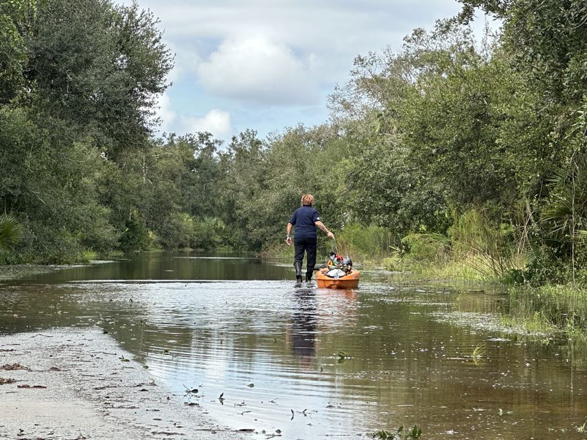 Una mujer en Sarasota prepara una canoa para navegar por una calle inundada tras el paso del huracán Milton.&nbsp; &nbsp;