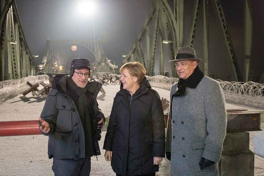 El cineasta Steven Spielberg junto a la canciller alemana Angela Merkel y el actor Tom Hanks en el puente Glienicker. (EFE). 