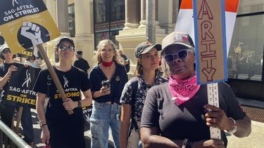 Shawn Batey, a la derecha, miembro de la Alianza Internacional de Empleados de los Escenarios Teatrales, protesta frente a las oficinas de Netflix en Nueva York el miércoles 9 de agosto de 2023, el día número 100 de la huelga de guionistas de Hollywood.&nbsp;