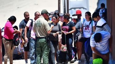 Un oficial de la Patrulla Fronteriza de Estados Unidos reúne a un grupo de migrantes que llegaron a la frontera con México.&nbsp;