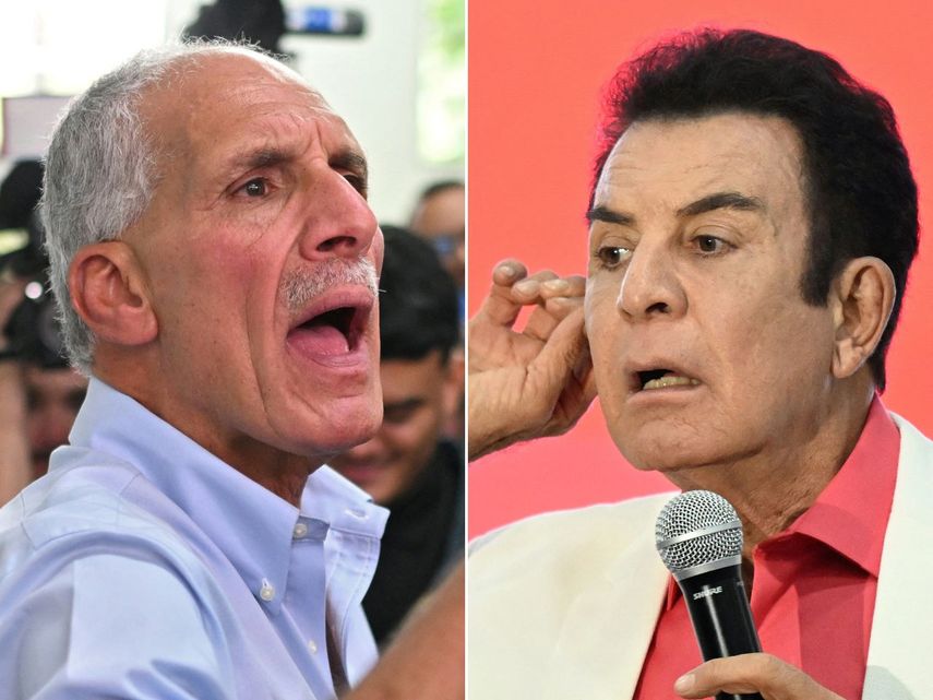 El candidato presidencial de Honduras del Partido Nacional, Nasry Asfura (izq.), muestra su dedo entintado después de emitir su voto en Tegucigalpa el 30 de noviembre de 2025, y el candidato por el partido opositor Liberal, Salvador Nasralla. El último es un exaliado de la izquierdista y prochavista presidenta de Honduras, Xiomara Castro.