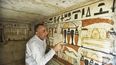 Mostafa Waziri, secretario general del Consejo Supremo de Antigüedades de Egipto, mira jeroglíficos dentro de una tumba recién descubierta cerca de la famosa pirámide escalonada de Zoser, en Saqqara, al sur de Egipto, el 19 de marzo del 2022.&nbsp;