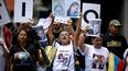 Estudiantes y familiares de presos políticos exhiben retratos de los reclusos durante una protesta para exigir su liberación frente a la Universidad Central de Venezuela (UCV) en Caracas, el 13 de mayo de 2026. Estudiantes universitarios y sus familias bloquearon la principal avenida de Caracas ese día para protestar por la desaparición forzada de unos 50 presos políticos en Venezuela y la muerte bajo custodia de aproximadamente 20 detenidos en la última década.