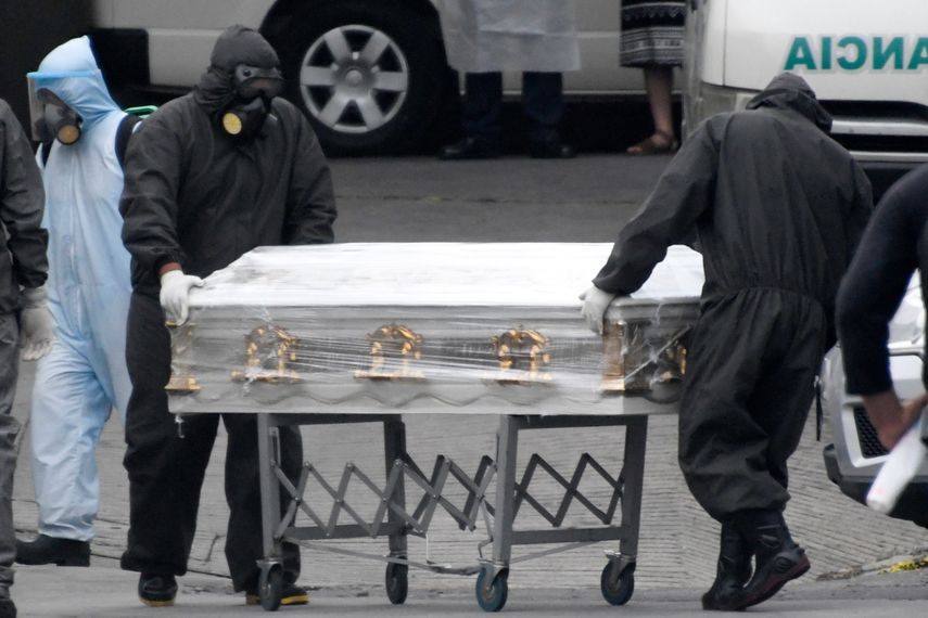 Los empleados de una compa&ntilde;&iacute;a funeraria mueven el ata&uacute;d de una v&iacute;ctima de COVID-19 en el Hospital General de Enfermedades (Hospital General de Enfermedades), en la Ciudad de Guatemala el 13 de julio de 2020. M&eacute;dicos, diputados y la Oficina del Procurador de los Derechos Humanos (PDH) La alarma sobre el inminente colapso del sistema de salud de Guatemala debido al aumento de los casos de COVID-19.