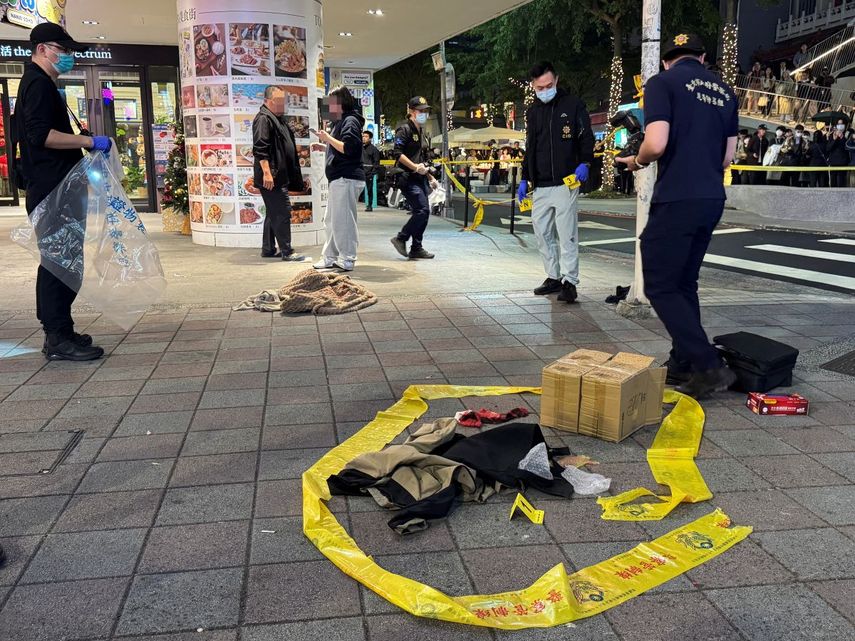 Esta imagen, tomada y publicada por la Agencia Central de Noticias de Taiwán (CNA) el 19 de diciembre de 2025, muestra a equipos forenses de la policía estableciendo un cordón policial frente a la librería Eslite Nanxi para recolectar evidencia después de que un sospechoso atacara indiscriminadamente a personas en las cercanías de Taipéi.