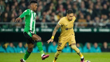 Raphinha del Barcelona pelea por el balón con Abner del Real Betis en el encuentro de la liga española el miércoles 1 de febrero del 2023.&nbsp;