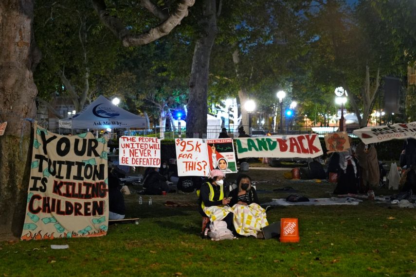 Gente montando guardia ante un campamento de manifestantes propalestinos en el campus en la Universidad del Sur de California, el sábado 4 de mayo de 2024 en Los Ángeles.