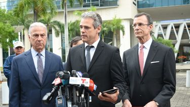 El propietario heredero de la compañía Havana Docks Corporation, Mickael Behn, en el centro, habla a la prensa, acompañado de sus abogados.