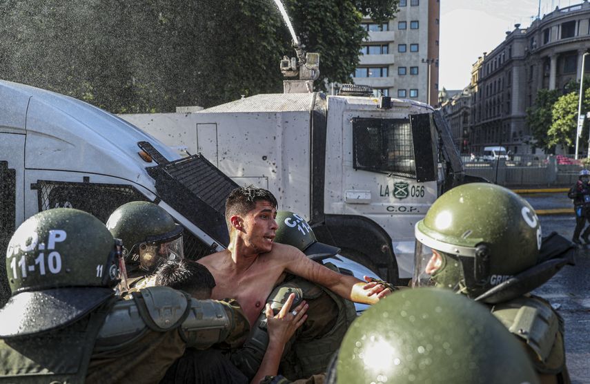 Un manifestante es detenido por la policía durante una protesta contra el presidente Sebastián Piñera exigiendo su renuncia en Santiago de Chile, el miércoles 18 de noviembre de 2020