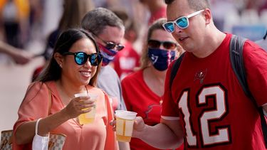 Unas personas caminan cerca de un sitio donde se llevan a cabo actividades previas al Super Bowl LV el viernes 5 de febrero de 2021, en Tampa, Florida.&nbsp;