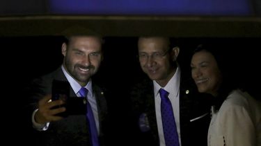 El legislador Eduardo Bolsonaro, hijo del presidente brasileño Jair Bolsonaro, izquierda, tomándose una selfie durante una ceremonia de juramentación en la Asamblea Nacional en Brasilia.