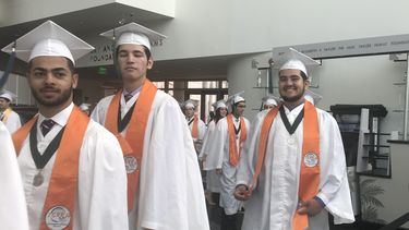 Alumnos del centro educacional especializado TERRA Environmental Research Institute se dirigen al podio del Adrienne Arsht Center Ziff Opera House, para recibir sus diplomas de graduación.