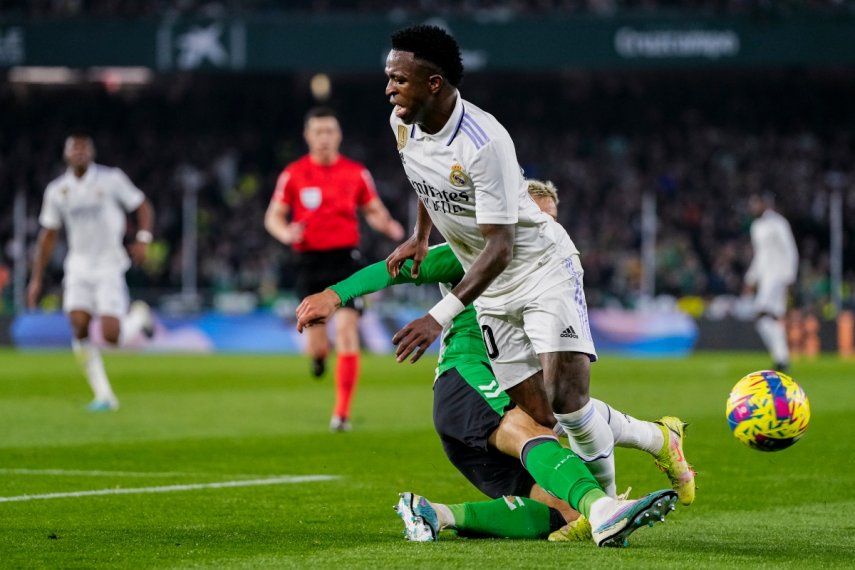 Vinicius Junior (primer plano) del Real Madrid trata de superar a Germán Pezzella del Real Betis en la Liga española, el domingo 5 de marzo de 2023.