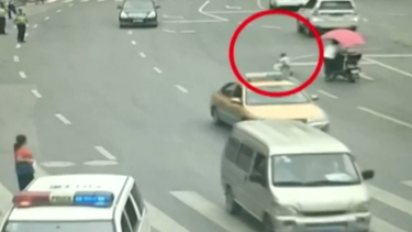 policia rescata a un bebe que por poco es atropellado en china