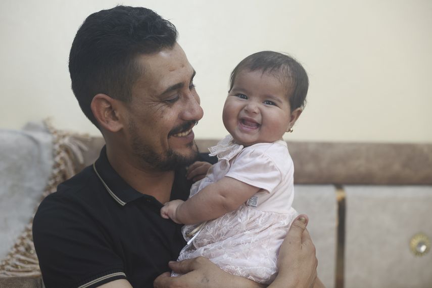 Khalil al-Sawadi juega con su hija adoptiva Afraa en Jinderis, Siria, el sábado 5 de agosto de 2023.&nbsp;