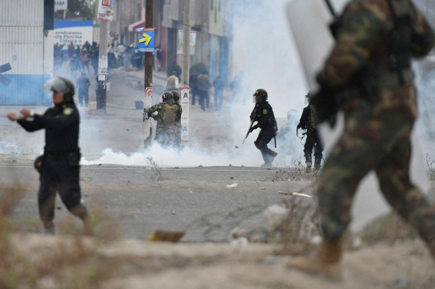 La policía antidisturbios choca con los manifestantes durante una protesta en la carretera Panamericana en el Cono Norte de Arequipa, Perú, el 12 de diciembre de 2022.