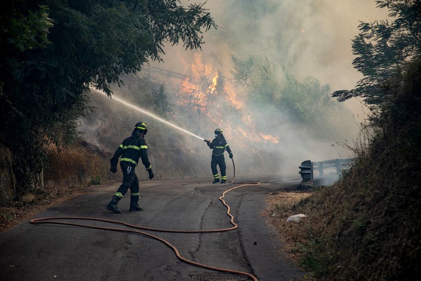 Los bomberos intentan sofocar un incendio cerca de la ciudad de Massarosa, en el centro de Italia, el 20 de julio de 2022.