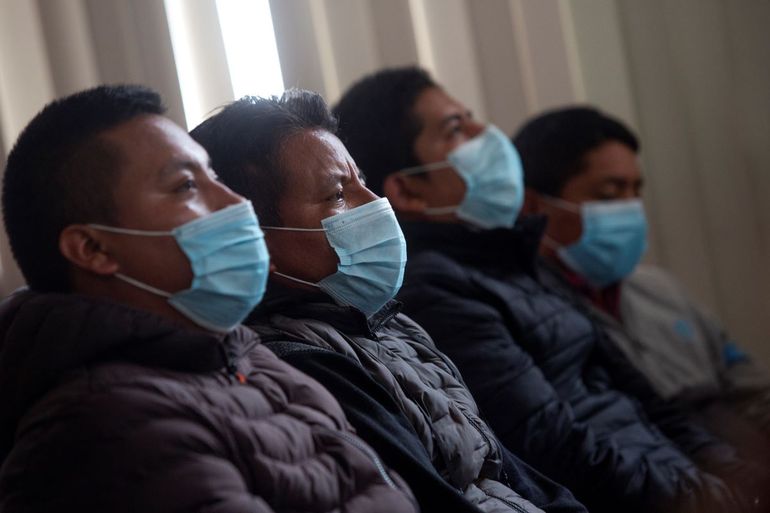 Hombres que presuntamente forman parte de una red de trata de personas esperan el inicio de una audiencia en los tribunales de justicia de Ciudad de Guatemala, el viernes 4 de febrero de 2022.