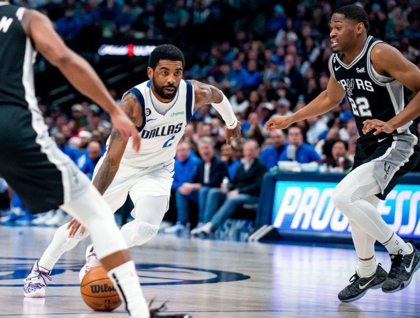 Foto del 23 de febrero del 2023, el base de los Mavericks de Dallas Kyrie Irving avanza con el balón superando a Malaki Branham de los Spurs de San Antonio. La agencia libre comenzó y en tres horas lograron $1 billón en cambios