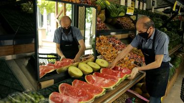 Un trabajador dispone fruta para la venta en un mercado. &nbsp;