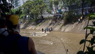Algunos más osados han optado por cruzar, montándose en las tuberías aéreas que cruzan el Guaire de lado a lado, sostenidos de los hierros que soportan la estructura.