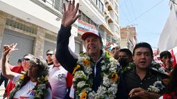 El expresidente boliviano y candidato presidencial de la coalición Alianza Libre, Jorge Tuto Quiroga Ramírez (centro), saluda a sus simpatizantes durante una visita al mercado de abastos Vicente Ochoa en La Paz el 7 de agosto de 2025. Bolivia celebrará elecciones presidenciales el 17 de agosto.&nbsp;