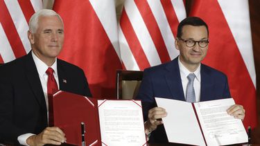 El vicepresidente de Estados Unidos, Mike Pence, y el primer ministro de Polinia, Mateusz Morawiecki, enseñan el acuerdo que firmaron en Varsovia.